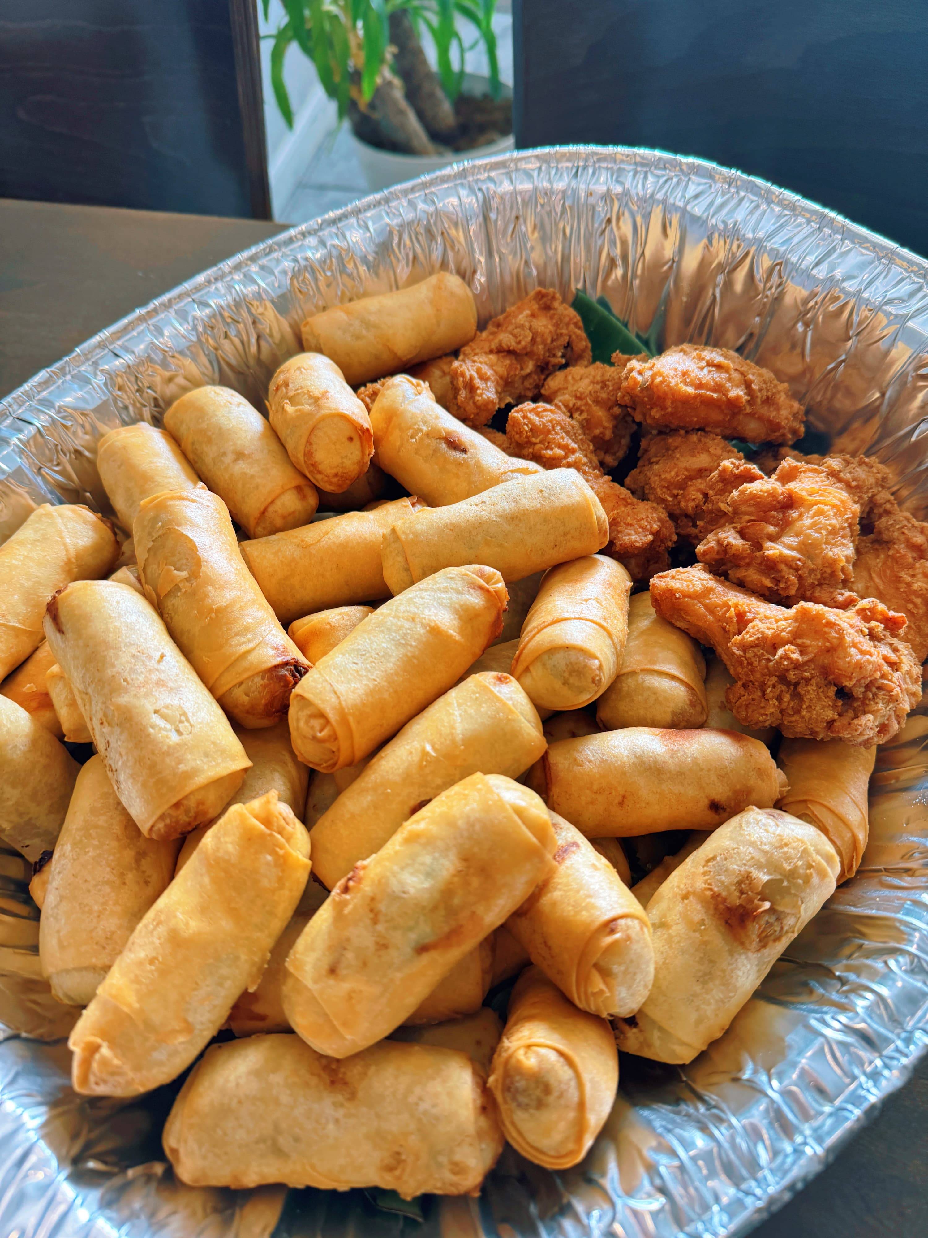 Fresh spring rolls and chicken wings appetizer platter