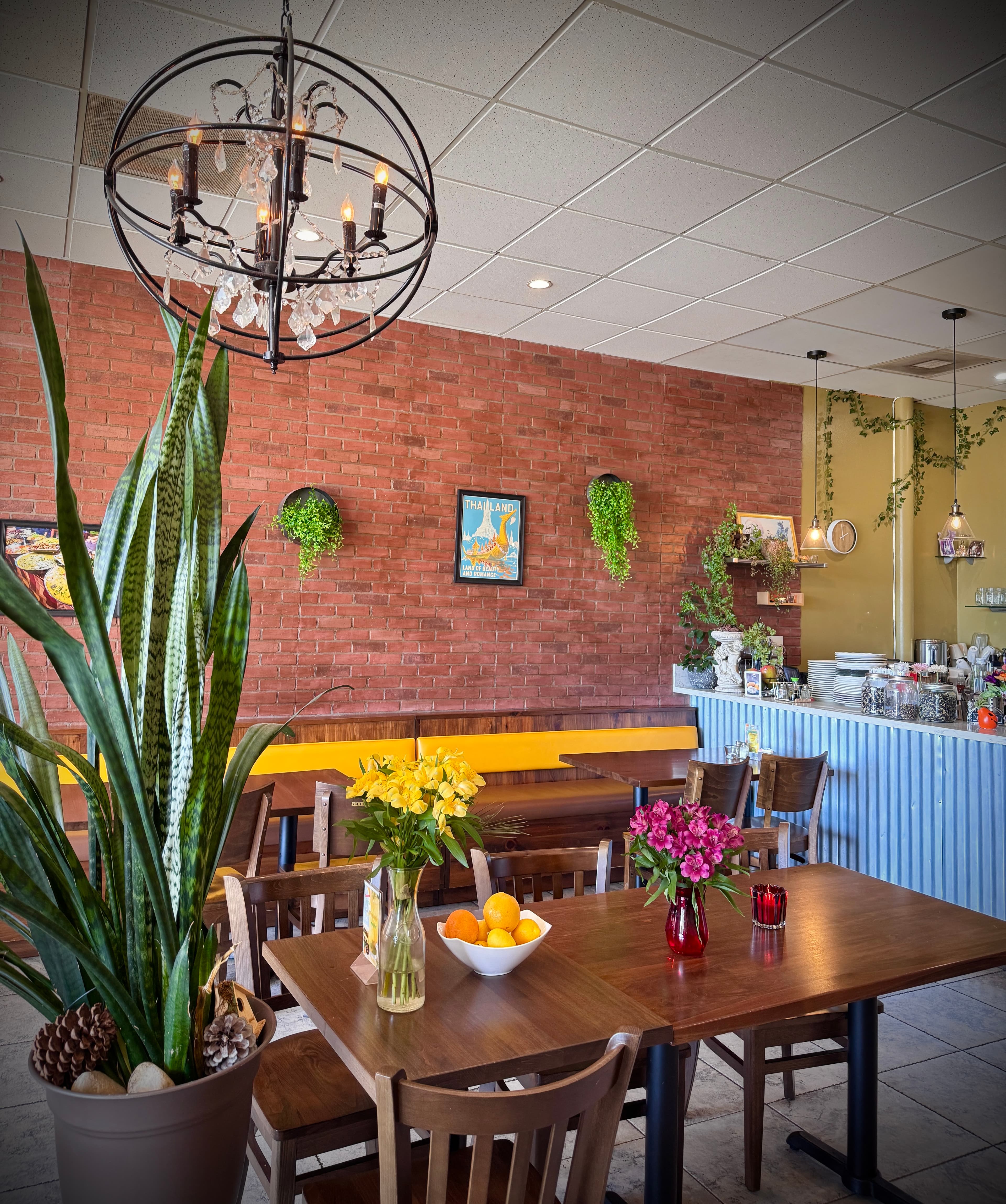 Cozy interior of The Yard Thai restaurant with warm lighting and traditional Thai decor